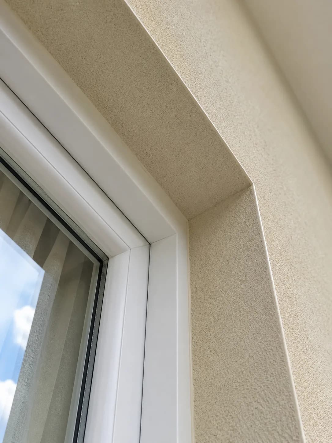 Window reveal detail showing clean render finish at junction