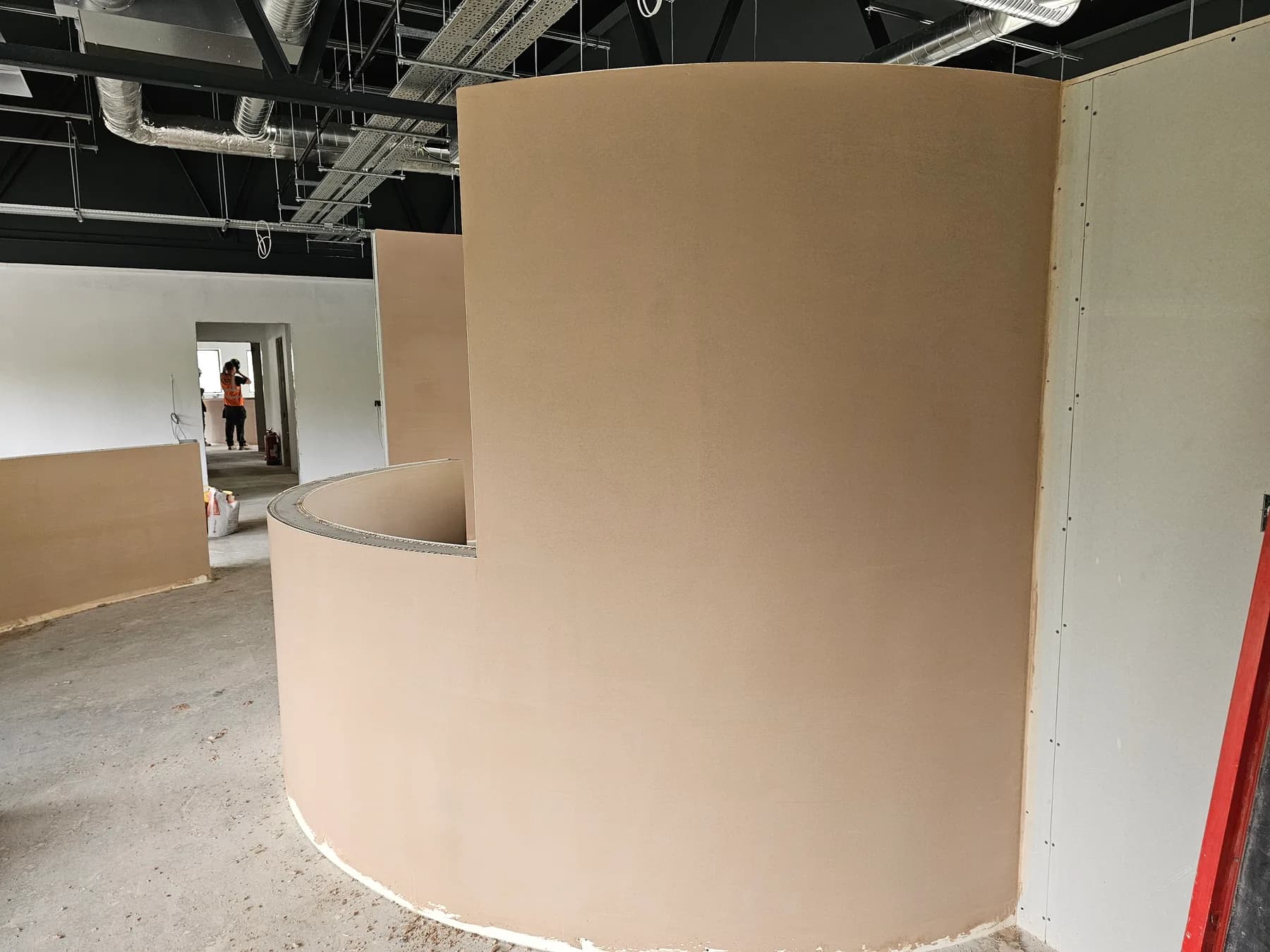 Curved commercial reception wall finished in smooth plaster